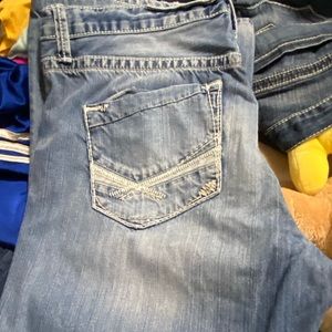 Several pair of men’s BKE jeans showing 3 pair.